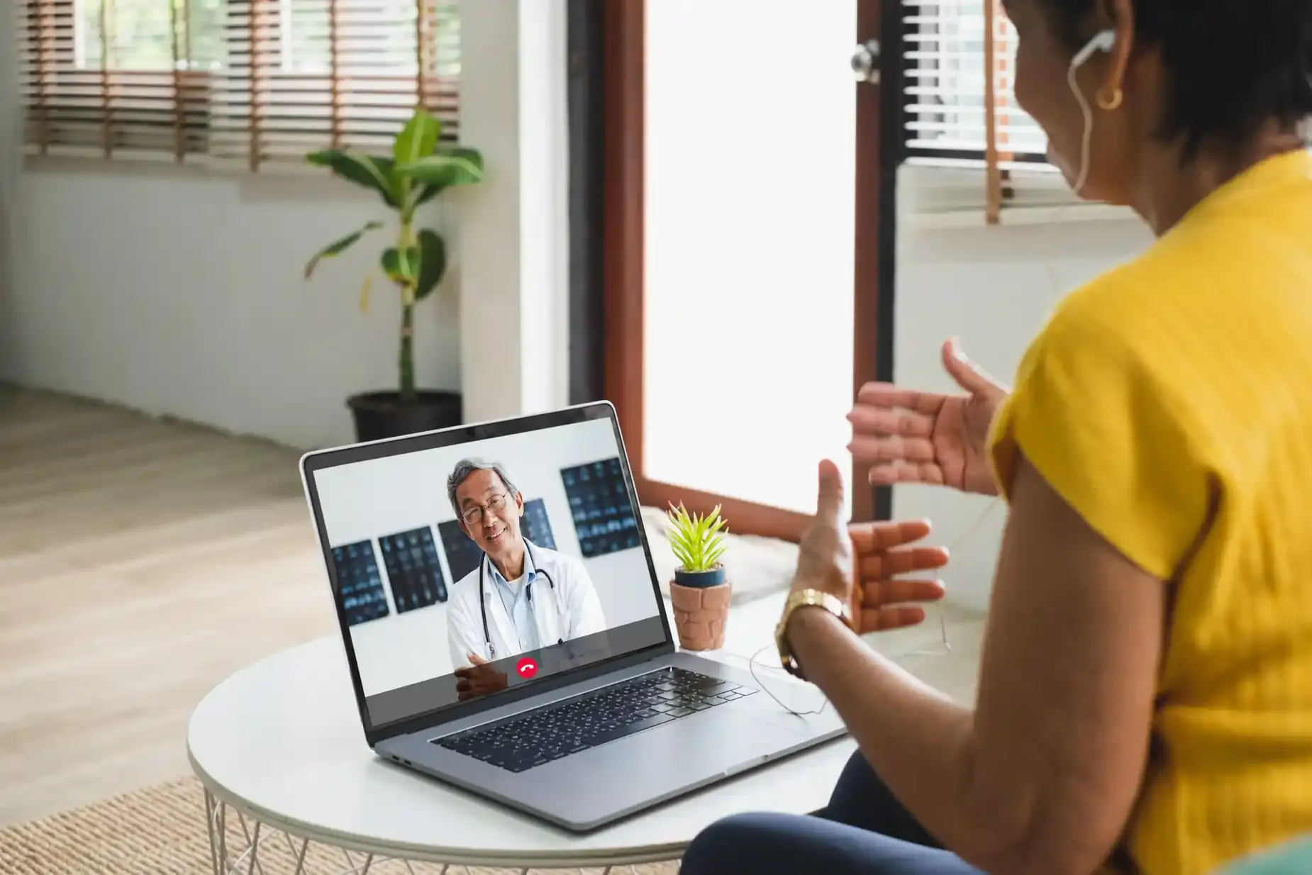A patient on a video call with a doctor from home