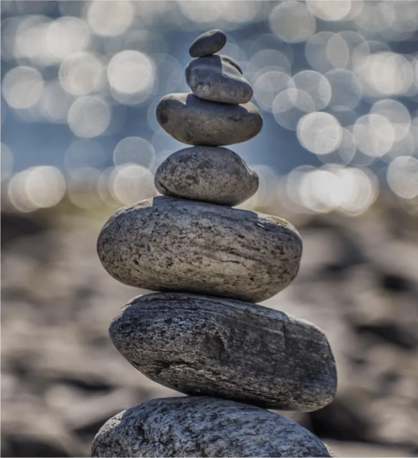 A stack of smooth balanced stones on a beach
